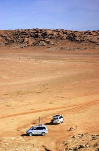 View of car on desert land