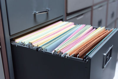Close-up of multi colored envelopes in locker