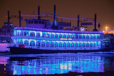 Reflection of illuminated building in water at night