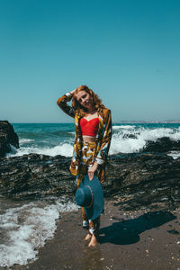 Portrait of fashionable woman standing on beach