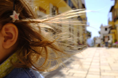 Close-up of girl on footpath