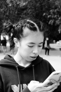 Close-up of young woman using smart phone