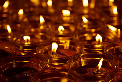 Lit diyas in darkroom during diwali