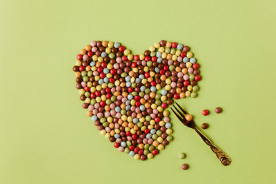 Directly above shot of multi colored candies against green background