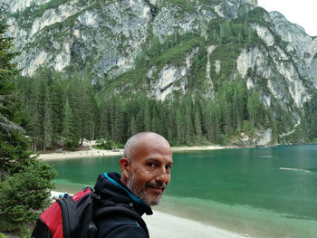 Portrait of man in lake against mountains