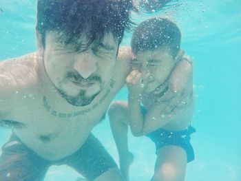 Young couple swimming in pool