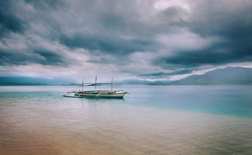 Scenic view of sea against sky and a boat