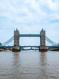 View of bridge over river against cloudy sky