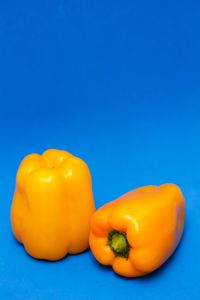 Close-up of yellow bell peppers on blue background