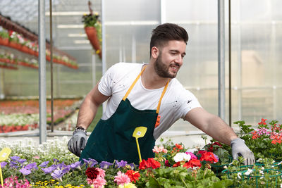 Young man working at flower shop
