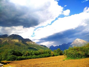 Scenic view of mountains against cloudy sky