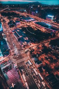 High angle view of city lit up at night