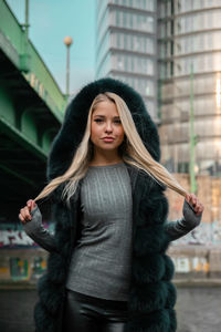 Beautiful young woman standing in city