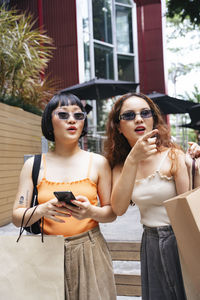 Portrait of young woman wearing sunglasses outdoors