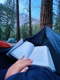 Midsection of woman reading book