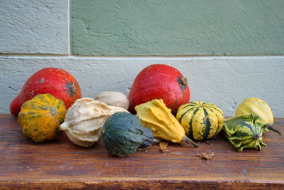 Closeup of colorful pumpkins on the wooden table outside the house