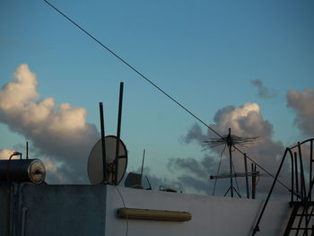 Low angle view of cables against blue sky