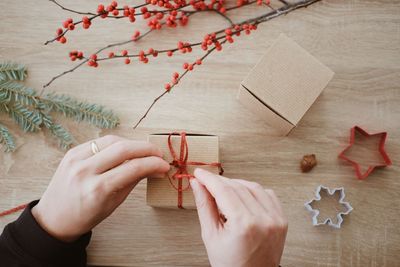High angle view of hand holding christmas decoration on table