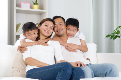 Happy family sitting on sofa at home