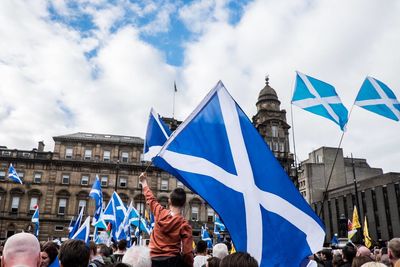 People holding scottish flags