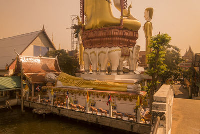 Temple by building against sky