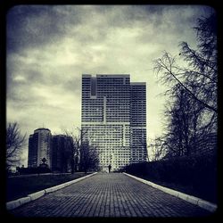 Buildings against cloudy sky