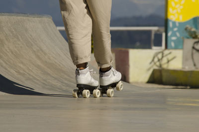 Low section of person roller skating outdoors