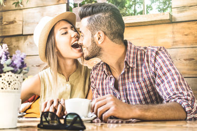 Romantic tourist couple spending leisure time at outdoor restaurant