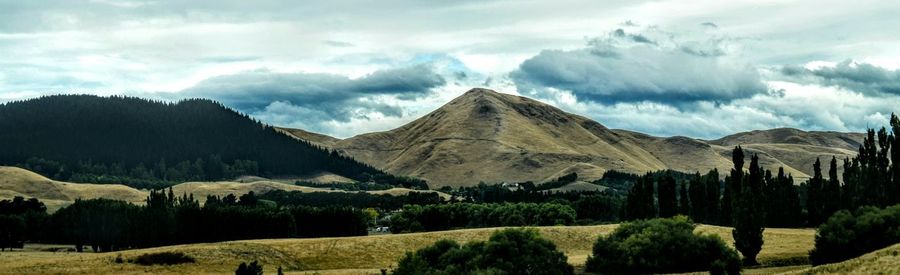 Scenic view of mountains against cloudy sky