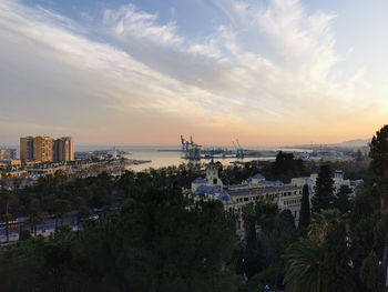 High angle view of buildings against cloudy sky