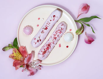 High angle view of pink rose on white plate