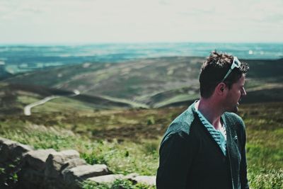 Man standing on landscape against sky