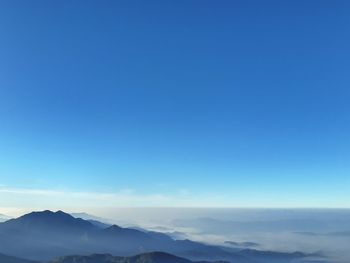 Scenic view of mountains against clear blue sky