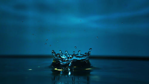 Close-up of water splashing against sky