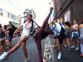 People dancing on street in city