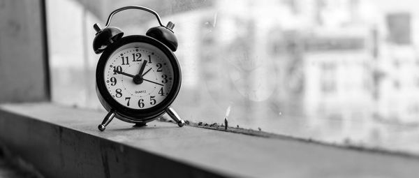 Close-up of clock on table