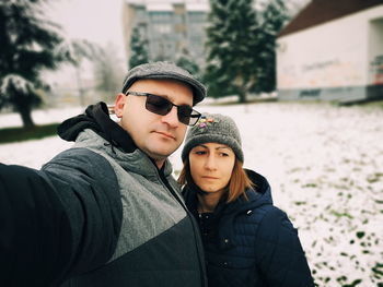 Portrait of couple standing outdoors during winter