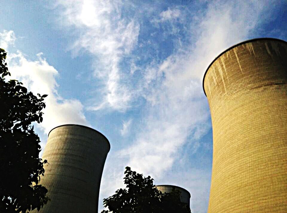 low angle view, architecture, built structure, sky, building exterior, tower, cloud - sky, tall - high, cloud, tree, no people, cloudy, outdoors, day, modern, high section, blue, nature, tall, sunlight