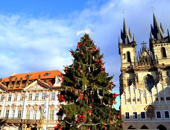 Low angle view of christmas tree and church of our lady before tyn in town square