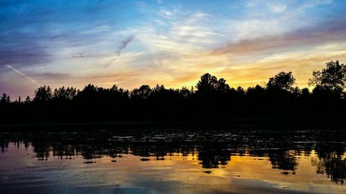 Scenic view of lake at sunset