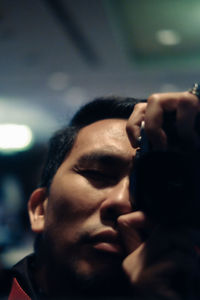 Close-up portrait of young man looking away