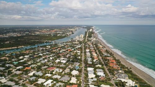 High angle view of sea and cityscape against sky