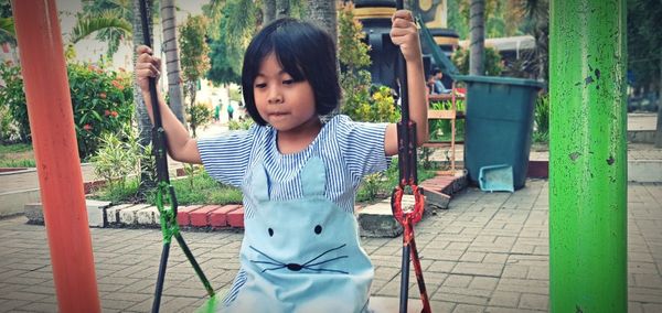 Girl swinging in park