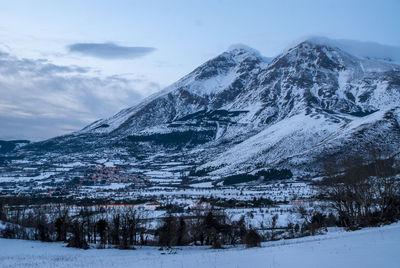 Scenic view of snowcapped mountains against sky