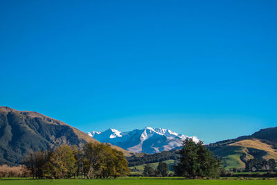 Scenic view of mountains against clear blue sky