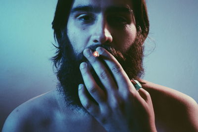 Portrait of young man smoking cigarette