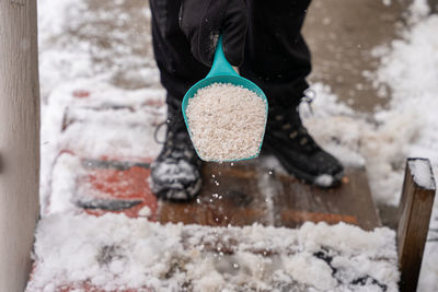 Rock salt ice melt is being spread on your walkway to melt the ice and snow from your path