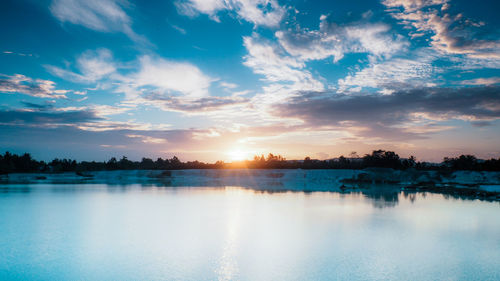 Scenic view of lake against sky during sunset