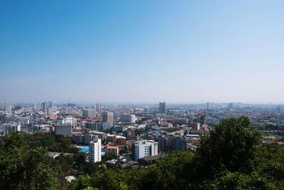 High angle view of buildings against clear blue sky