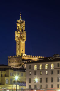 Low angle view of illuminated buildings against sky at night